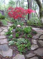 flowers and plants in circle created by flagstone walkway